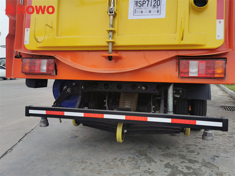Road sweeper truck with rear spraying nozzles